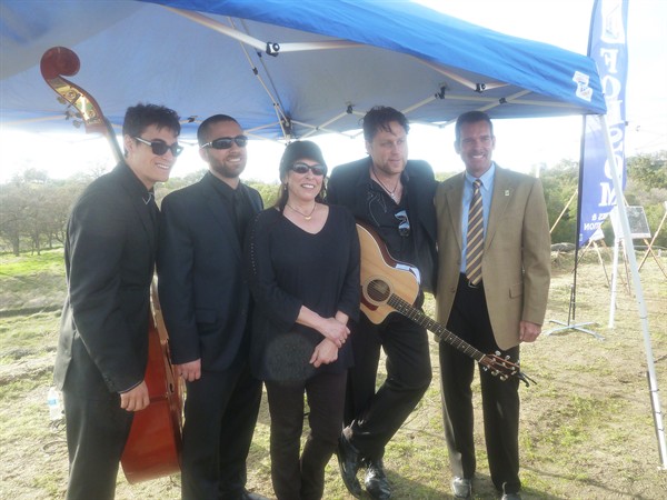 Cindy Cash, daughter of Johnny Cash, poses with a cover band at the groundbreaking of a 2.5-mile bike trail named after the legendary singer. Cody Drabble : Capital Public Radio